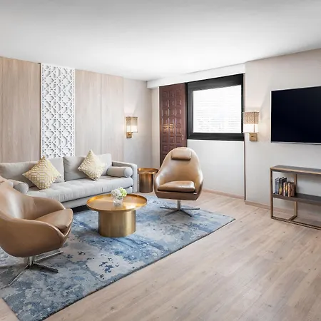 Makarem Ajyad Makkah Hotel Mecca Exterior photo The photo displays a modern living room designed with a contemporary aesthetic. It features:

- A light-colored wooden wall, enhancing a warm atmosphere.
- A comfortable gray sofa adorned with several decorative pillows.
- Two stylish, tan-colored ar